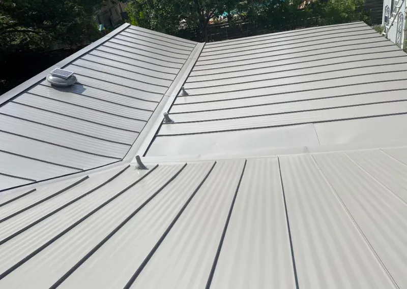 Solar attic fan installed on a metal roof for Roof Ventilation in Woodside